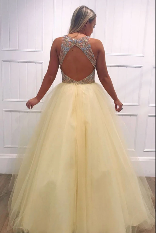 Yellow beaded tulle evening gown detail view showing intricate beadwork and V-neckline