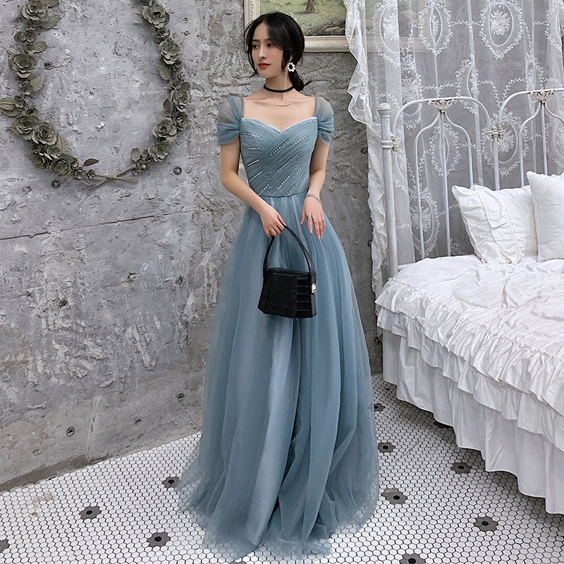 Blue tulle evening gown back view showing elegant design details