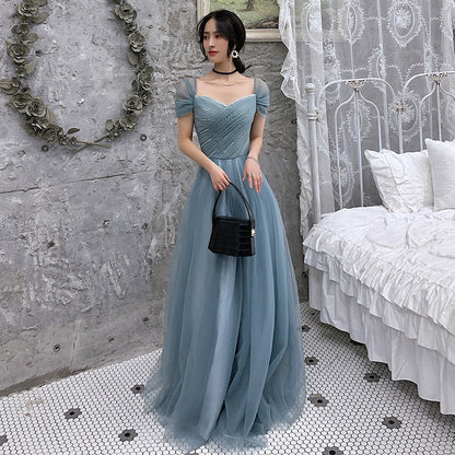 Blue tulle evening gown back view showing elegant design details