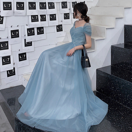 Blue tulle long prom dress with A-line silhouette and romantic flowing skirt