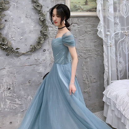 Blue tulle prom dress side angle showcasing flowing layers and silhouette