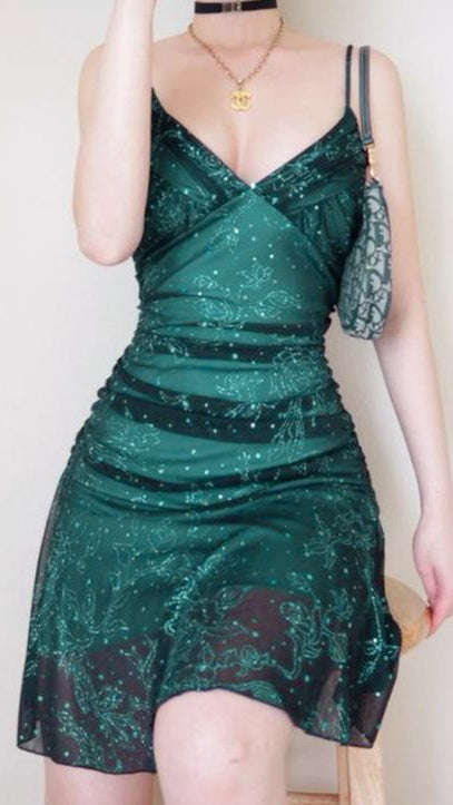 Green sequin dress worn by a person on a plain background